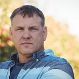portrait-farmer-standing-apple-orchard